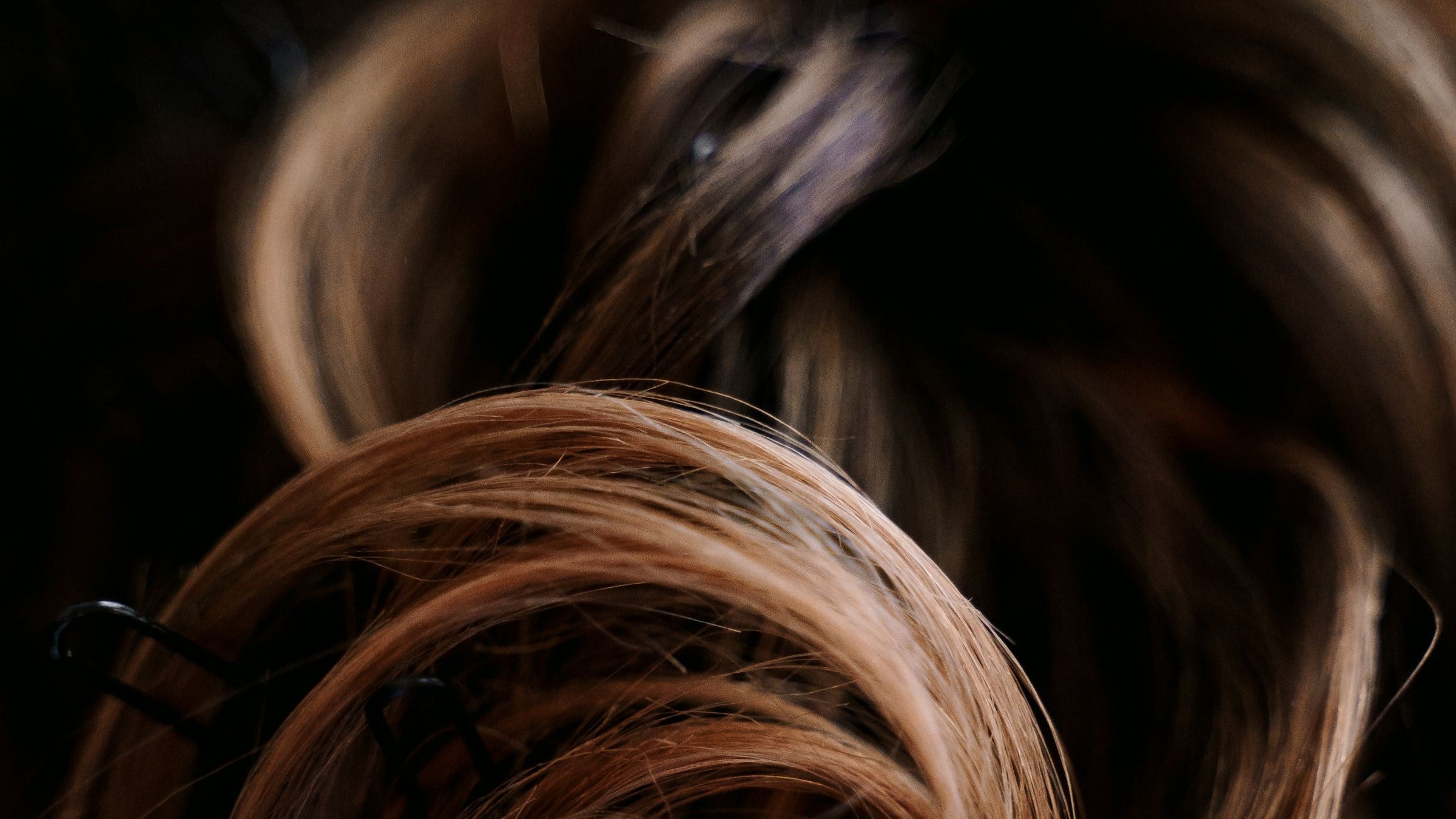 Long hair loosely pinned up, close up in warm light